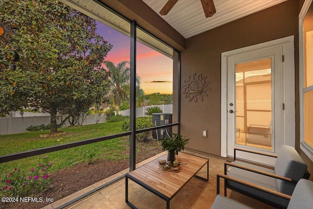 sunroom / solarium featuring ceiling fan and wooden ceiling