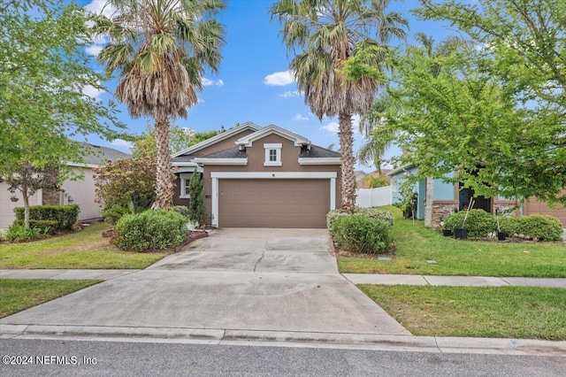 view of front of house featuring a front lawn and a garage