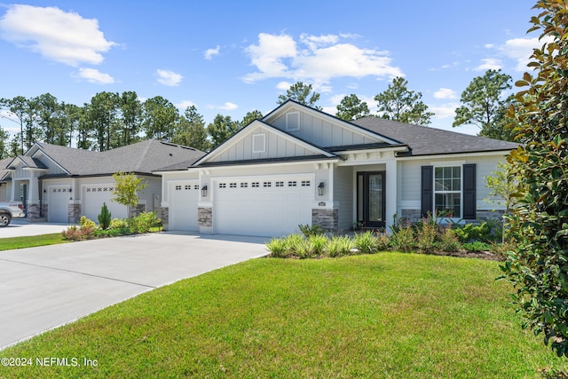 craftsman-style house featuring a garage and a front lawn