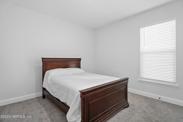 bedroom with light colored carpet