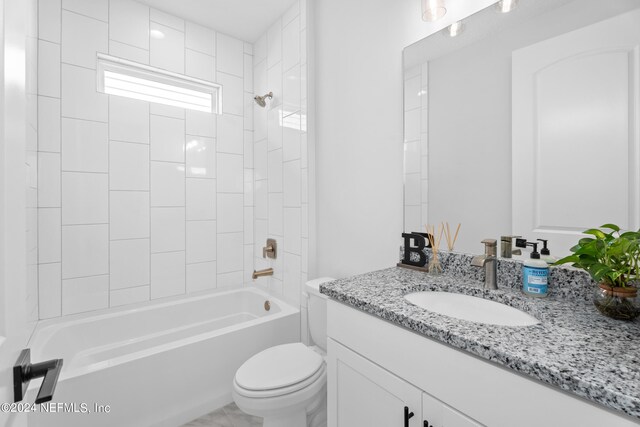 full bathroom with vanity, toilet, and tiled shower / bath