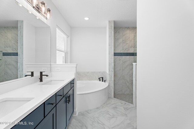 bathroom featuring vanity and independent shower and bath