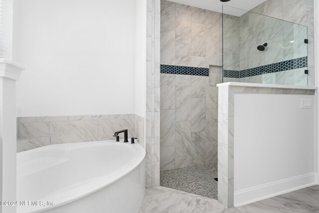 bathroom featuring separate shower and tub