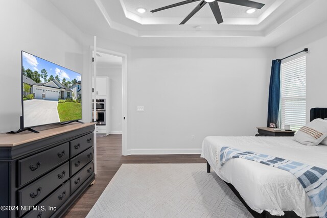 bedroom featuring ceiling fan and dark hardwood / wood-style flooring