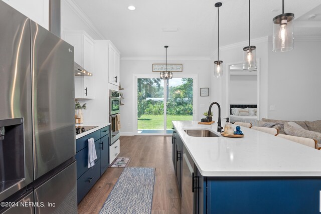 kitchen featuring white cabinets, appliances with stainless steel finishes, sink, an island with sink, and blue cabinets