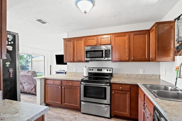 kitchen with light countertops, appliances with stainless steel finishes, and visible vents