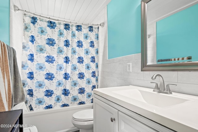 bathroom with shower / tub combo with curtain, vanity, toilet, and tile walls