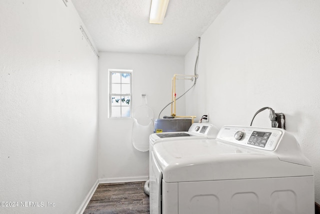 laundry room with a textured ceiling, washing machine and dryer, laundry area, dark wood-style flooring, and baseboards