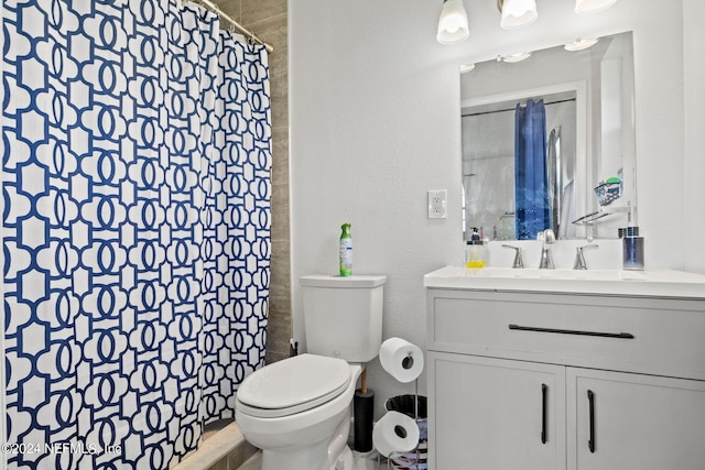 full bathroom with toilet, a textured wall, vanity, and a shower with curtain