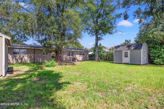 view of yard with an outdoor structure and a storage shed