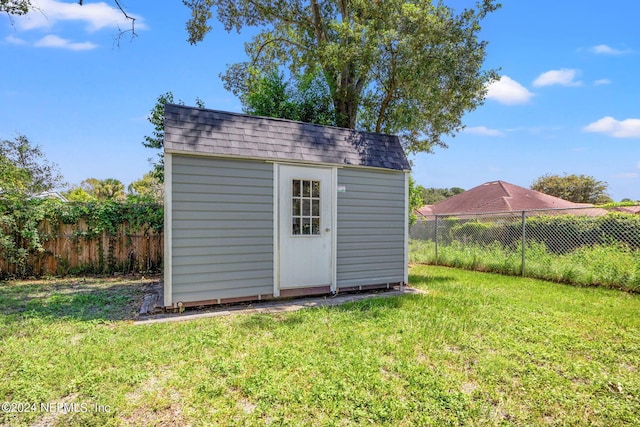 view of shed with a fenced backyard