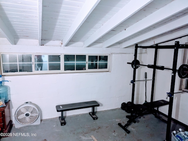 workout room featuring concrete block wall