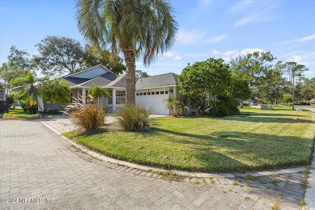 view of front of property with a garage and a front lawn