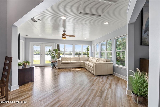 living room featuring french doors, ceiling fan, and light hardwood / wood-style floors