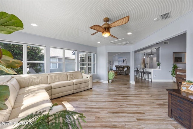 living room with ceiling fan and wood-type flooring