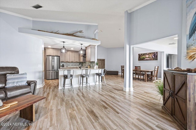 dining room with light hardwood / wood-style flooring and ornamental molding