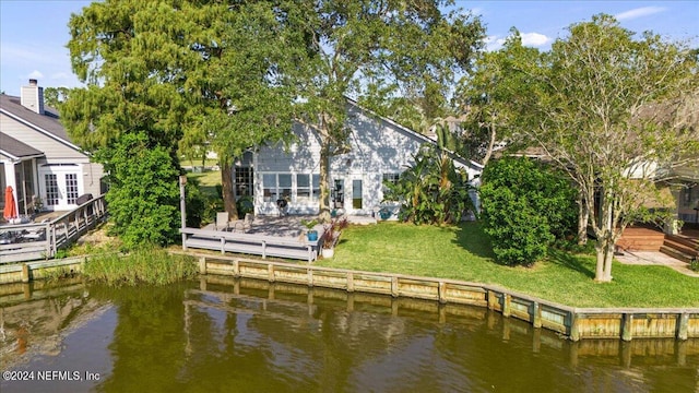 exterior space with a yard and a water view