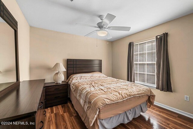 bedroom featuring ceiling fan and dark hardwood / wood-style floors