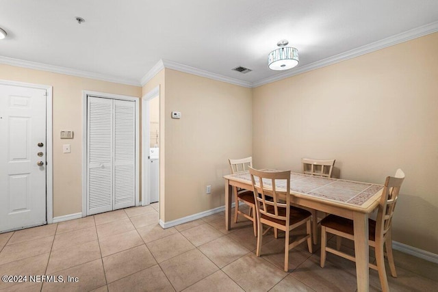 tiled dining area featuring ornamental molding