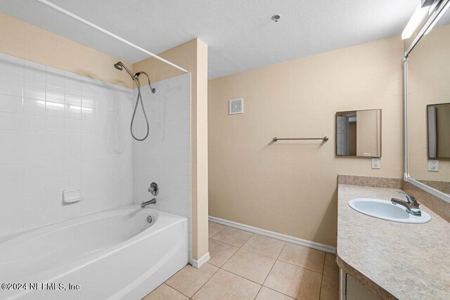 bathroom featuring vanity, tiled shower / bath combo, and tile patterned flooring