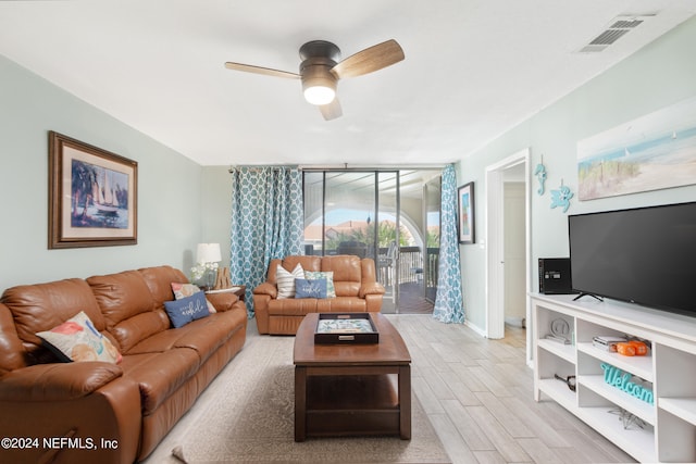 living room featuring ceiling fan and light wood-type flooring