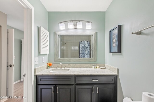 bathroom featuring a shower with curtain, vanity, toilet, and wood-type flooring