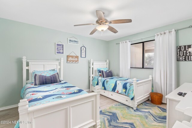 bedroom featuring light wood-type flooring and ceiling fan