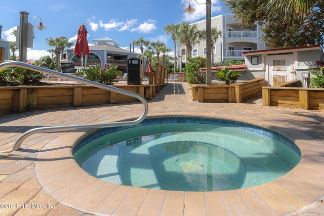 view of pool with an in ground hot tub