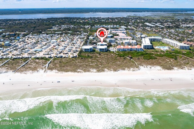 drone / aerial view featuring a beach view and a water view