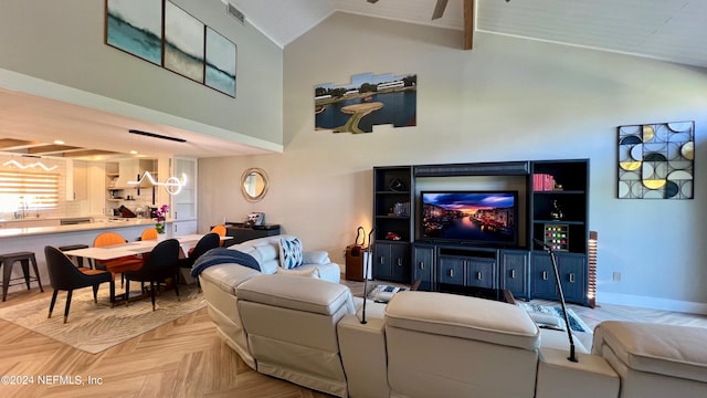 living room with ceiling fan with notable chandelier, lofted ceiling, and light parquet flooring