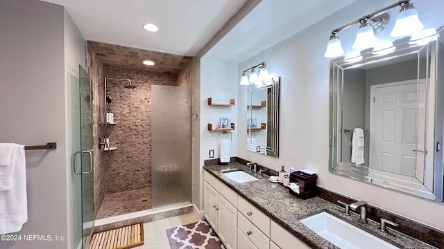 bathroom with vanity, a shower with shower door, and tile patterned floors