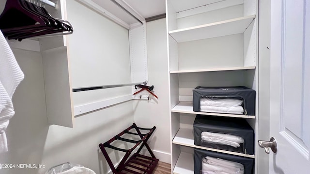 walk in closet with wood-type flooring