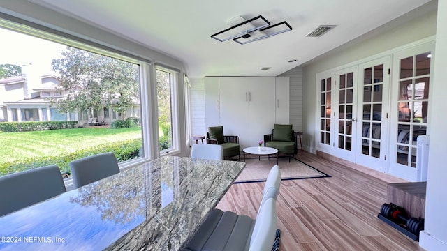 wooden deck featuring a lawn and french doors