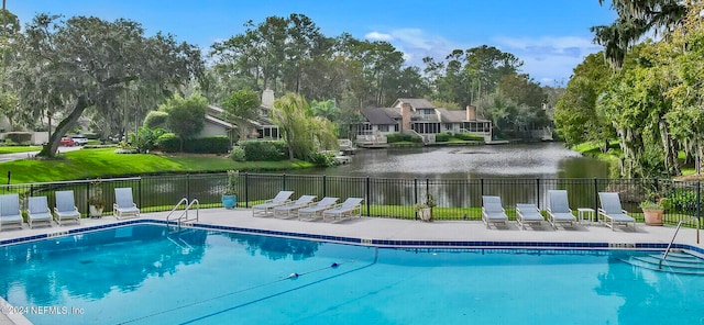 view of swimming pool featuring a water view