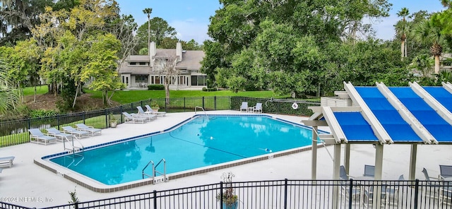 view of pool featuring a lawn and a patio