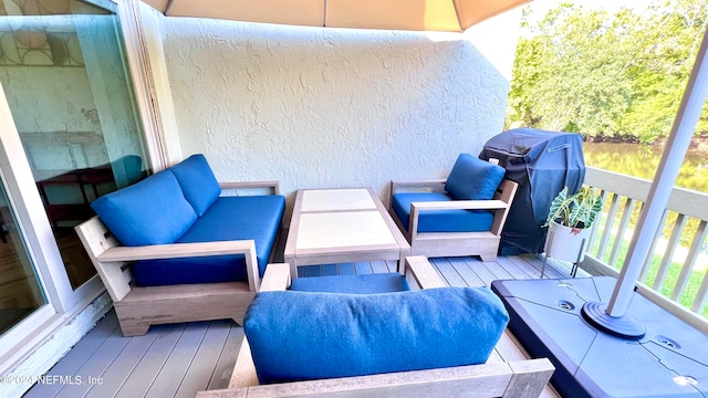 balcony with an outdoor hangout area and a grill