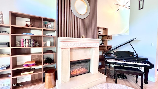 living area featuring a high end fireplace and light hardwood / wood-style floors