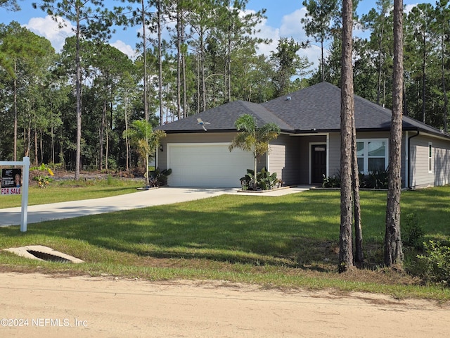 view of front of house featuring a garage, driveway, a front lawn, and roof with shingles