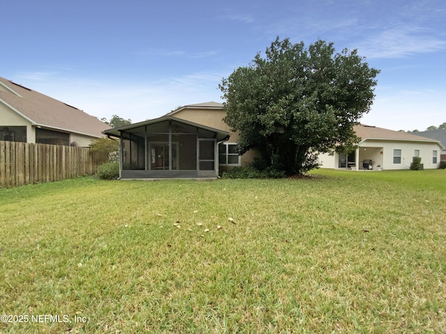 view of yard with a sunroom and fence