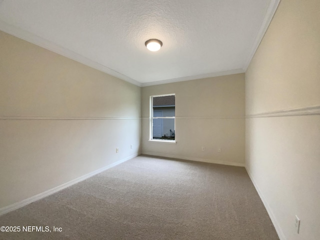 carpeted spare room featuring a textured ceiling and baseboards