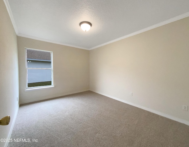 carpeted empty room featuring a textured ceiling, crown molding, and baseboards