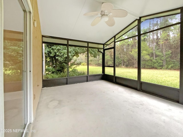 unfurnished sunroom featuring vaulted ceiling and a ceiling fan