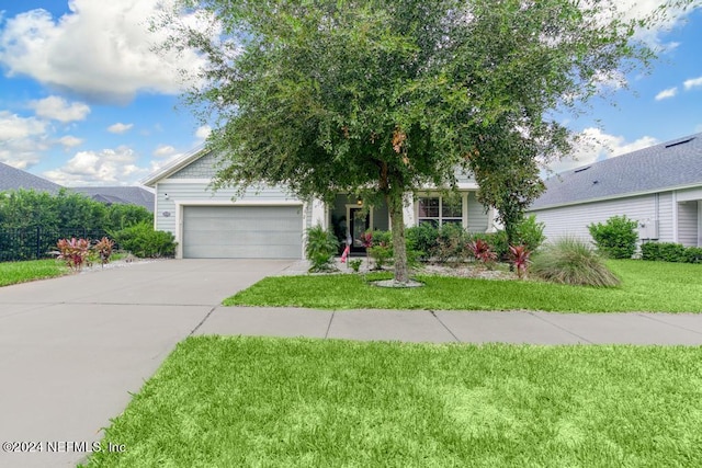 view of front of home with a garage and a front yard