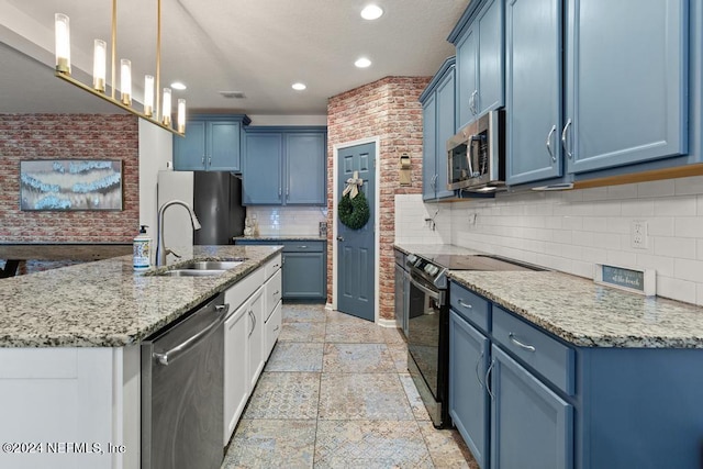 kitchen with blue cabinets, hanging light fixtures, sink, and appliances with stainless steel finishes