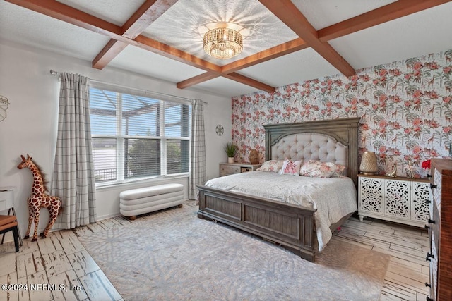 bedroom featuring coffered ceiling, a notable chandelier, and beamed ceiling