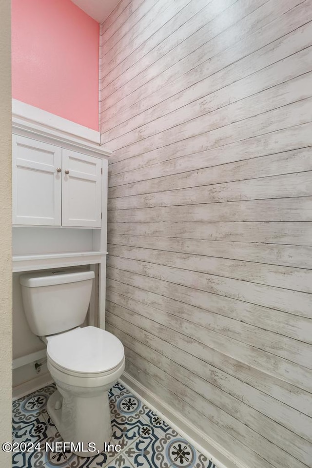 bathroom featuring toilet and tile patterned floors