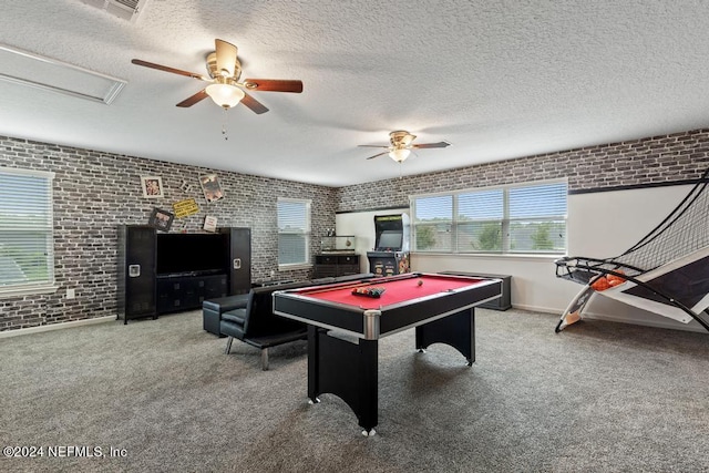 recreation room featuring brick wall, ceiling fan, and carpet