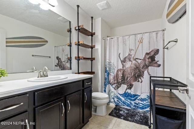 bathroom with tile patterned floors, walk in shower, toilet, vanity, and a textured ceiling