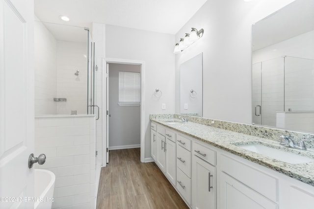 bathroom with vanity, plus walk in shower, and hardwood / wood-style floors