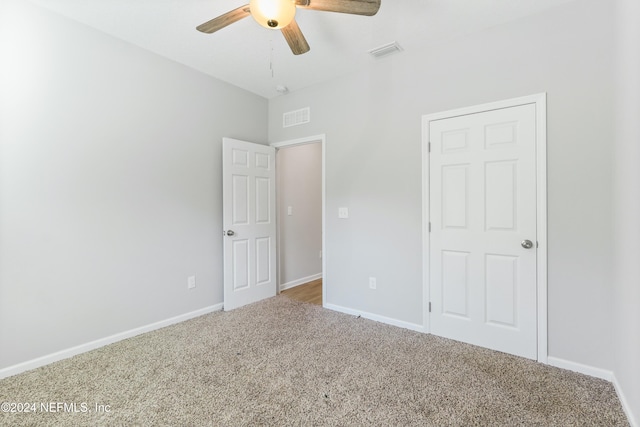 unfurnished bedroom featuring carpet and ceiling fan